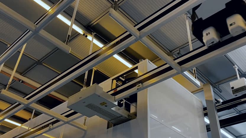 Overhead hoist transport vehicle on track inside a semiconductor fab
