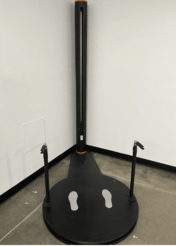 A standing 3D body scanner with its platform and handholds