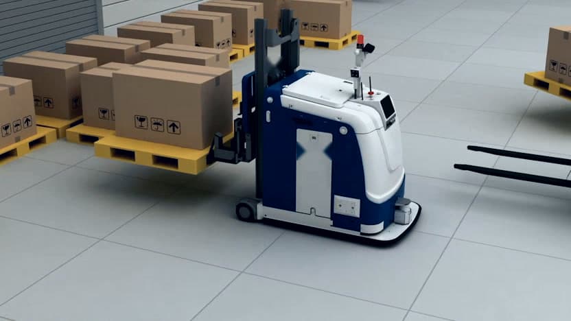 Automated guided vehicle moving pallets on a warehouse floor