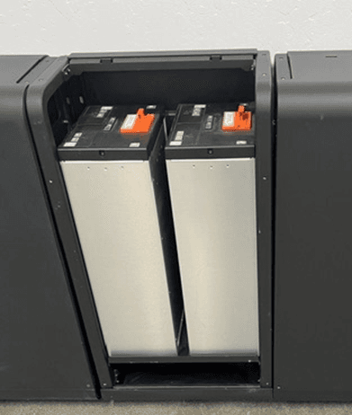 Two battery modules seated in a storage cabinet