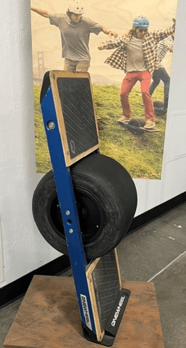 A one-wheel electric balance board on a display stand