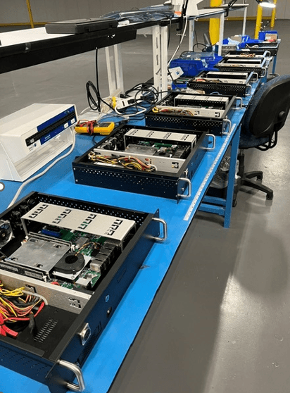 Server trays with integrated electronics lined up on a production bench